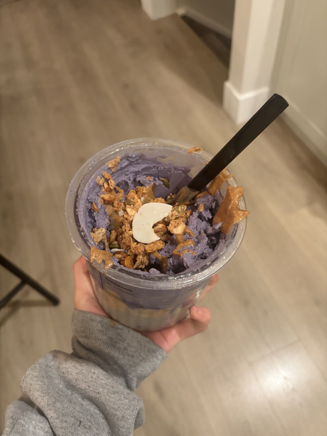 A berry bowl topped with granola and banana slices
